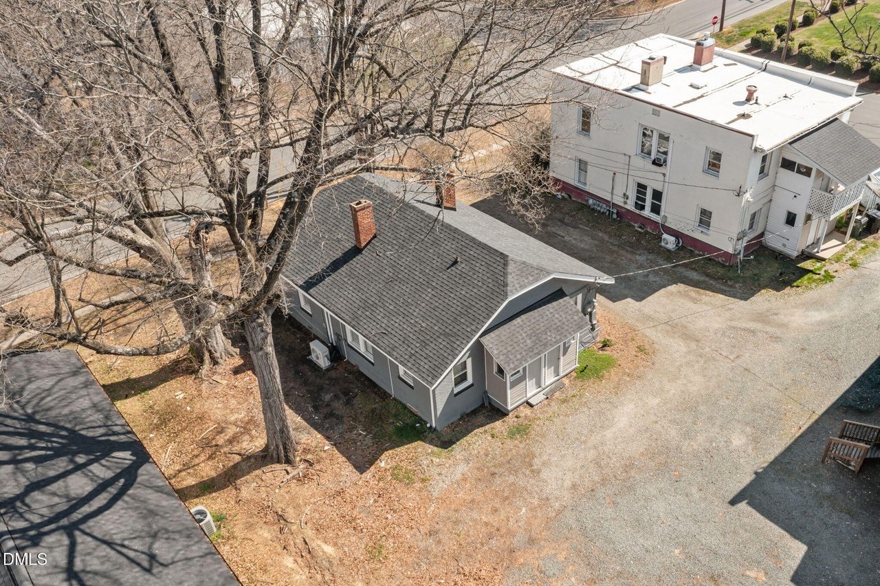 Aerial view of the grey brick duplex and gravel drive